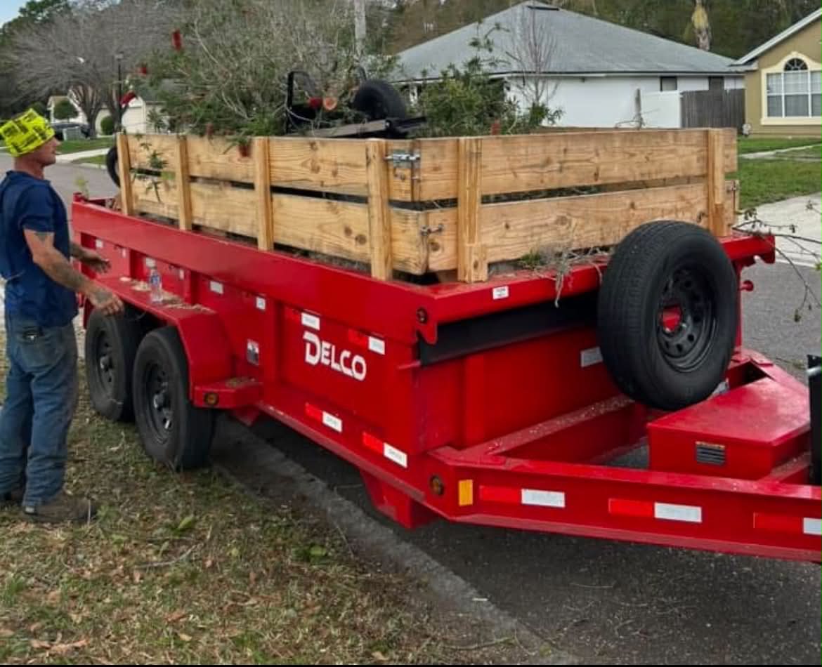 Red hauling trailer loaded with tree branches